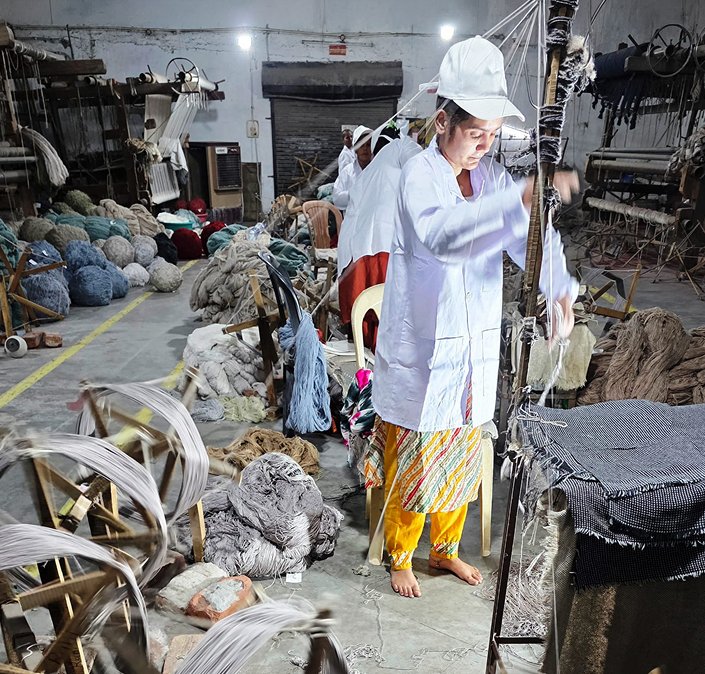 Skilled artisan preparing wool for Dialogues Collection luxury carpet – Habit Collection